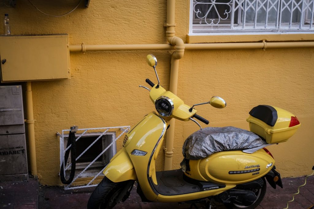yellow-scooter-parked-against-vibrant-wall-30179000 A yellow scooter parked against a matching painted wall in Istanbul, Türkiye.